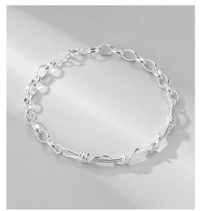 Detailed macro shot of twisted silver chain links with adjustable lobster clasp
