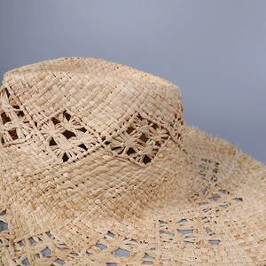 Handwoven raffia sun hat with diamond hollow pattern and fringed wide brim for women