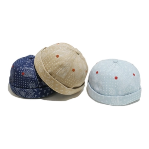 Retro paisley pattern docker hats in navy, beige, and blue with cotton canvas texture
