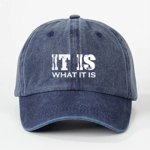 Close-up of IT IS WHAT IT IS print on washed denim blue baseball cap texture