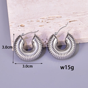 Detail of silver C-shape textured earrings showing 3cm size and 15g weight on stone