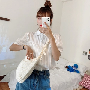 Mirror selfie showing floral canvas shoulder bag with puff sleeve shirt and denim skirt