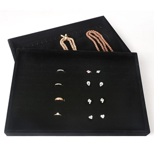 Black velvet jewelry display tray for rings earrings and necklaces on professional counter