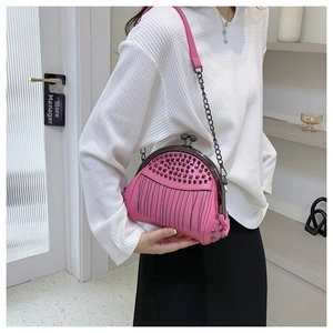 Close-up of pink rivet tassel bag with metallic chain strap and punk style accents