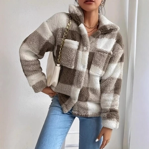 Close-up of the soft plush texture and brown plaid pattern on this women's autumn jacket