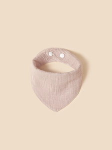 Macro detail of breathable lotus pink muslin cotton baby bib with snap fasteners