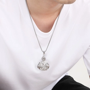 Detailed view of Saint Jude religious pendant on box chain worn by male model