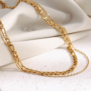 Detailed shot of double-layer 18K gold plated Figaro and cable chain necklace