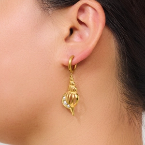 Elegant gold conch shell earrings with white pearl inlay shown on ear model
