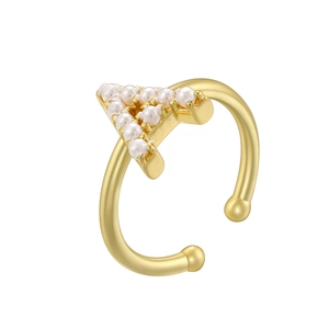 Detailed view of a golden triangle ring featuring inlaid pearls and polished bead ends
