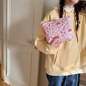Detail of pink quilted makeup bag with cute rabbit patterns and Sorakka brand label