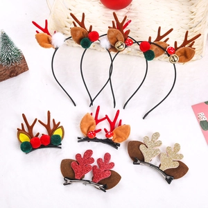 Detail of Christmas reindeer antler hair clips with glitter fabric and mini bell accents
