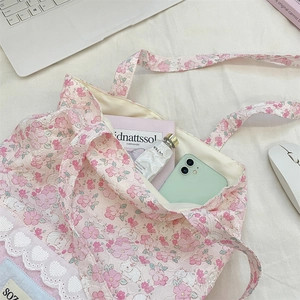 Detailed view of floral canvas tote bag with bunny print and lace trim for school