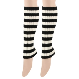 Detail of black and white striped knit leg warmers showing ribbed texture and elasticity