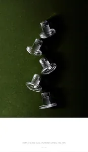 Detailed close-up of five clear crystal T-shaped glass candle holders on green background