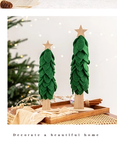 Detail of two green felt Christmas trees with wooden bases on a festive table