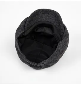 Close-up of wool newsboy cap interior showing black smooth lining and sweatband detail
