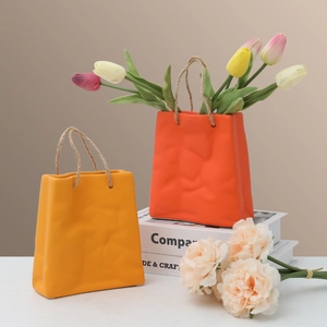 Creative handbag ceramic vases in bright orange and yellow with rustic hemp rope handles