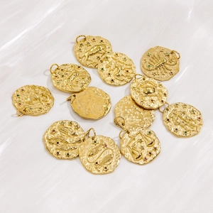 Golden 14K stainless steel zodiac coin charms with colorful cubic zirconia on white silk