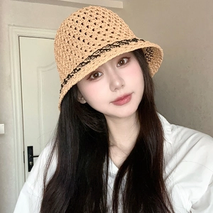 Close-up of khaki crochet straw bucket hat with black geometric line patterns