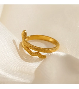 Close-up of gold snake ring featuring detailed scale texture and adjustable open band