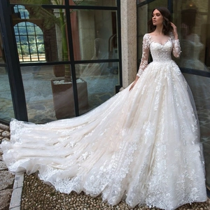 Elegant off-white ball gown wedding dress with floral lace appliques and long sleeves