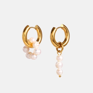 Elegant asymmetrical gold hoop earrings with clustered and dangling white pearls