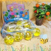 Macro view of boxed yellow squishy sugar balls with bee inserts for stress relief