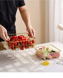 Detailed view of golden iron wire fruit baskets with elegant handles for home storage