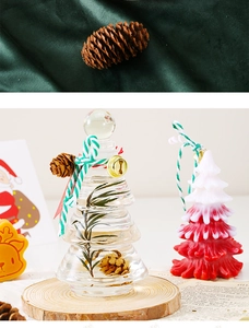 Christmas tree candle gift set with pine needles in glass jar on wooden base