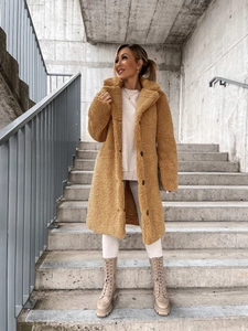 Detail of camel teddy faux fur texture and lapel design on long winter coat