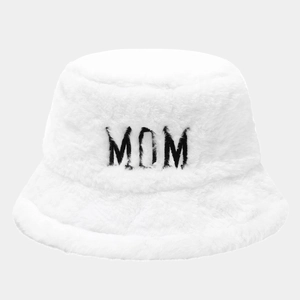 Detailed close-up of fluffy white plush bucket hat featuring black MOM embroidery