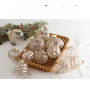 Detailed view of clear and gold glitter Christmas balls in a rustic woven basket