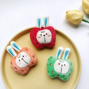 Three plush bunny brooches with fruit hats in a yellow plate for clothes decor