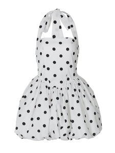 Detailed view of white polka dot halter dress with backless design and flared hemline