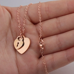 Polished rose gold heart lock and key necklaces set on minimalist O-link chain