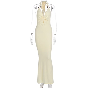 Detail of light yellow halter dress featuring metal ring buckle and front twist knot design