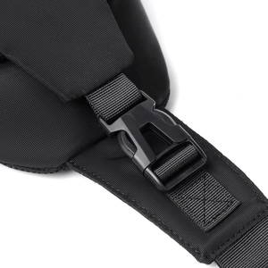 Close-up of durable black nylon shoulder strap with matte plastic buckle on chest bag