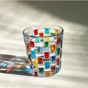 Macro shot of colorful woven glass texture with vibrant light reflections on a whiskey glass