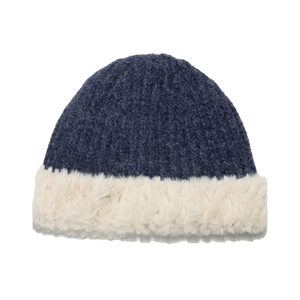 Close-up of navy knit winter hat featuring soft white faux fur trim and thick texture