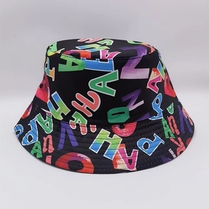 Detail of a black bucket hat featuring colorful ALOHA and HAPPY letter prints