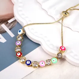 Macro shot of colorful evil eye beads and zircon stones on a gold adjustable bracelet