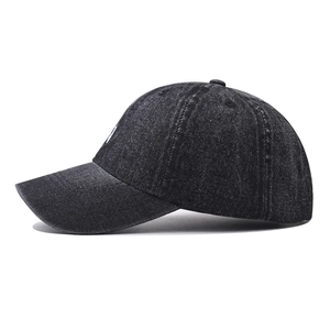 Side view of washed black denim baseball cap showing premium cotton twill texture