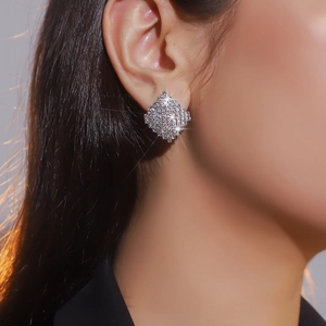 Elegant geometric square rhinestone stud earrings with sparkling diamonds on female model