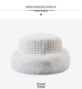Close-up of a white faux fur bucket hat featuring a textured woven crown and plush brim