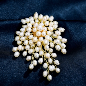 Handcrafted freshwater pearl brooch with gold wire wrap cluster and elegant tassel detail