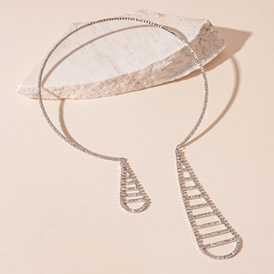Detailed close-up of a silver geometric tie collar with sparkling rhinestones and teardrops