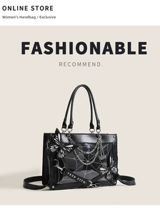 Gothic black tote bag featuring spider web panel with metal chains and butterfly detail