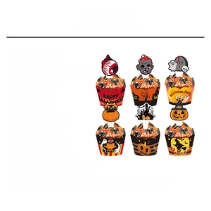 Detail of Halloween cake wrappers and toppers with pumpkin and ghost designs
