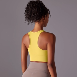 Detail view of the racerback design and breathable cut-out on a yellow sports bra